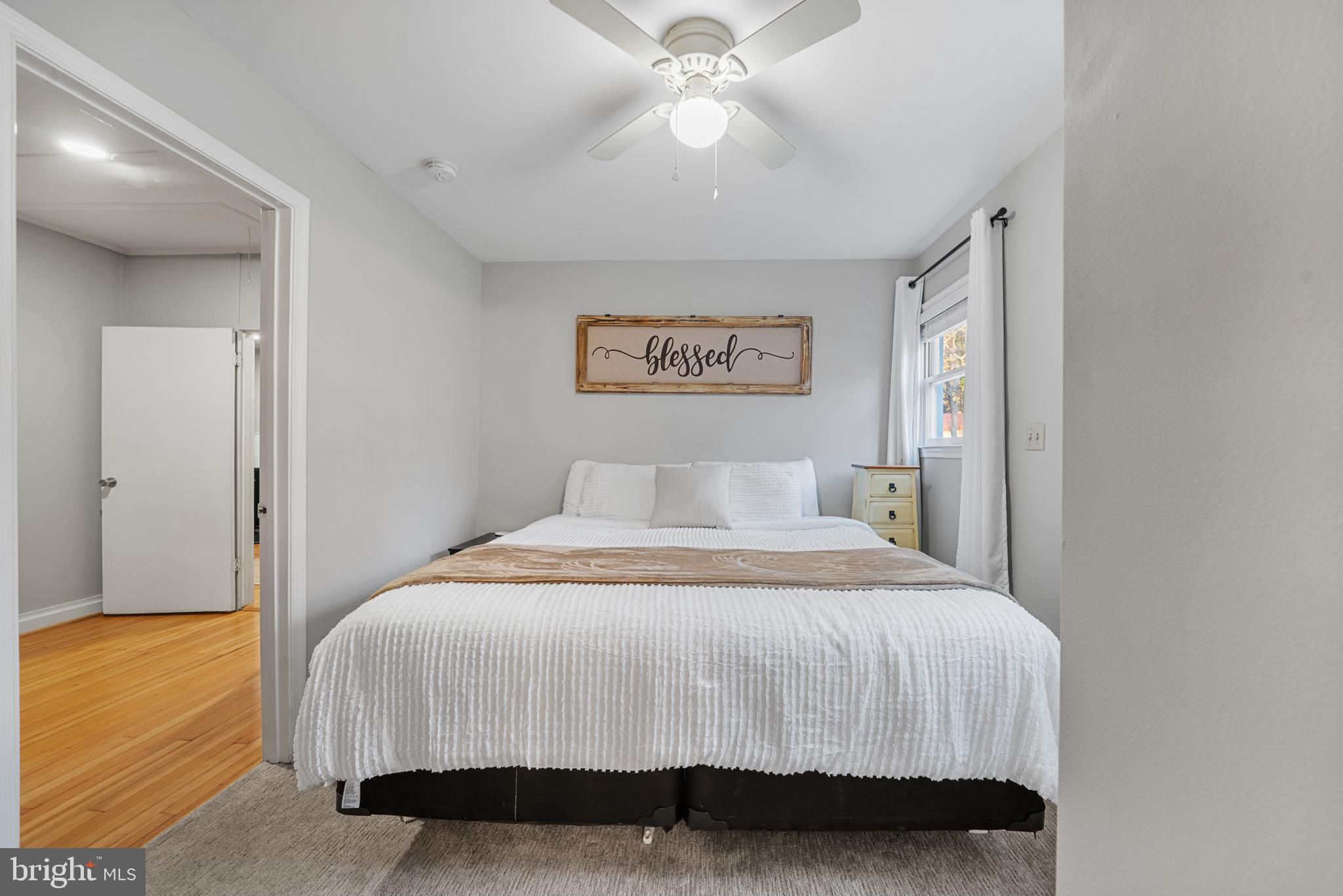 6015 Poplar Road St. Leonard, MD 20685 - Photo 29 of 35 a bedroom with a bed and a chandelier