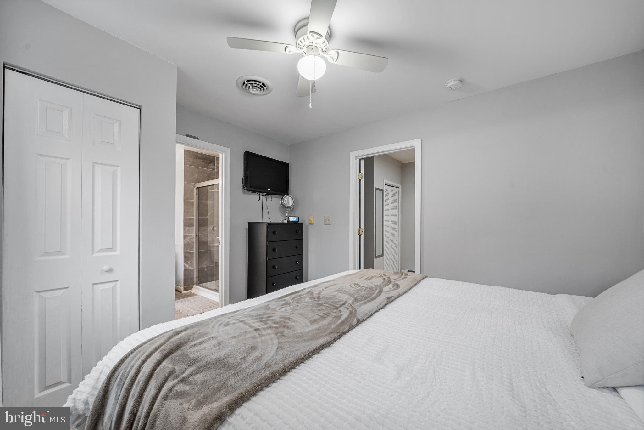 6015 Poplar Road St. Leonard, MD 20685 - Photo 30 of 35 a bedroom with a bed and a chandelier