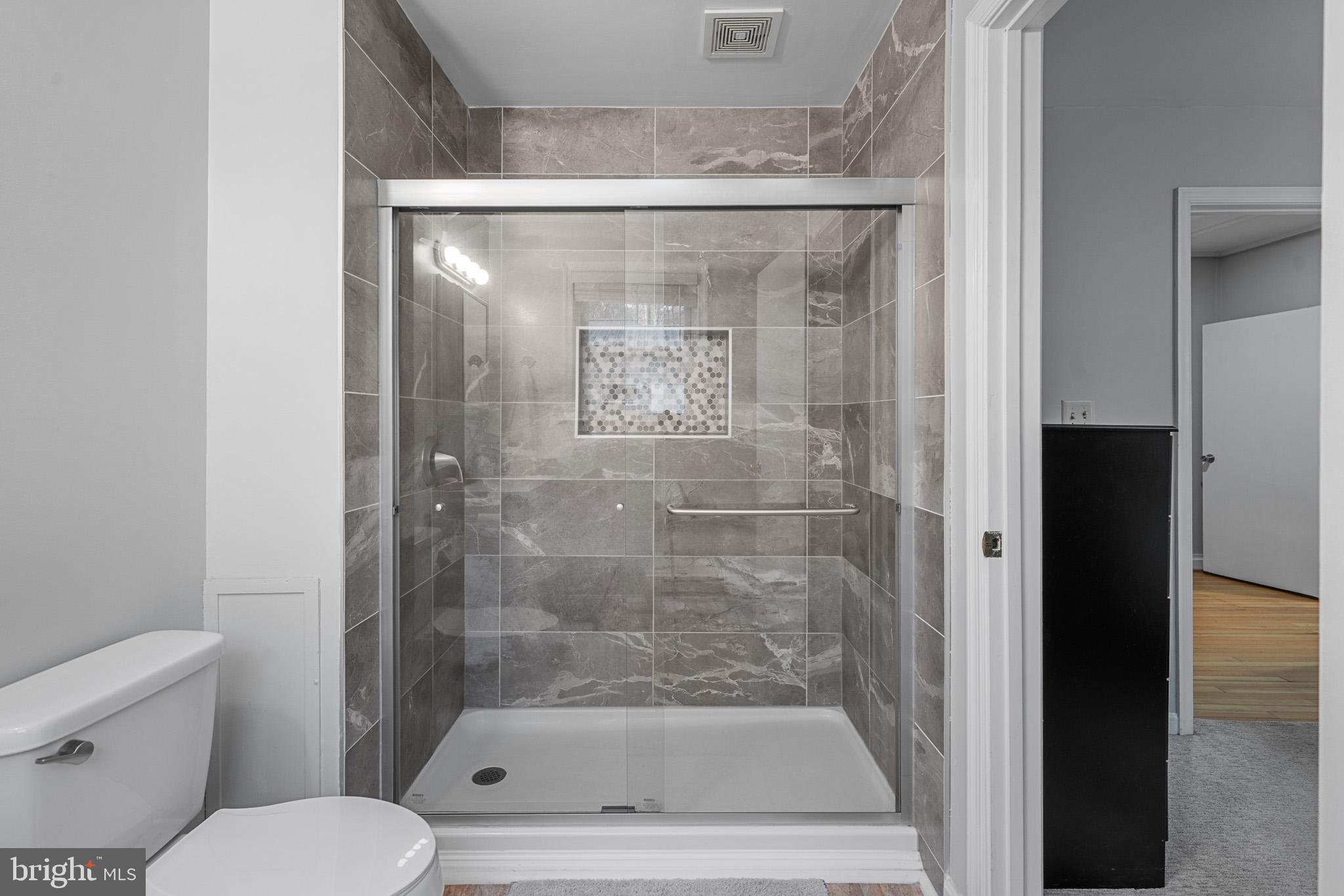 6015 Poplar Road St. Leonard, MD 20685 - Photo 32 of 35 a bathroom with a shower and toilet