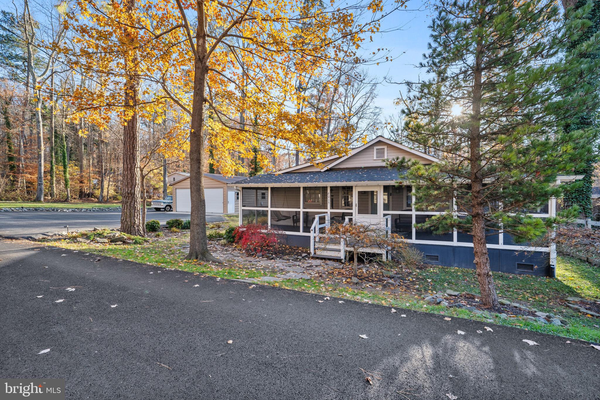 6015 Poplar Road St. Leonard, MD 20685 - Photo 5 of 35 a front view of a house with garden and porch