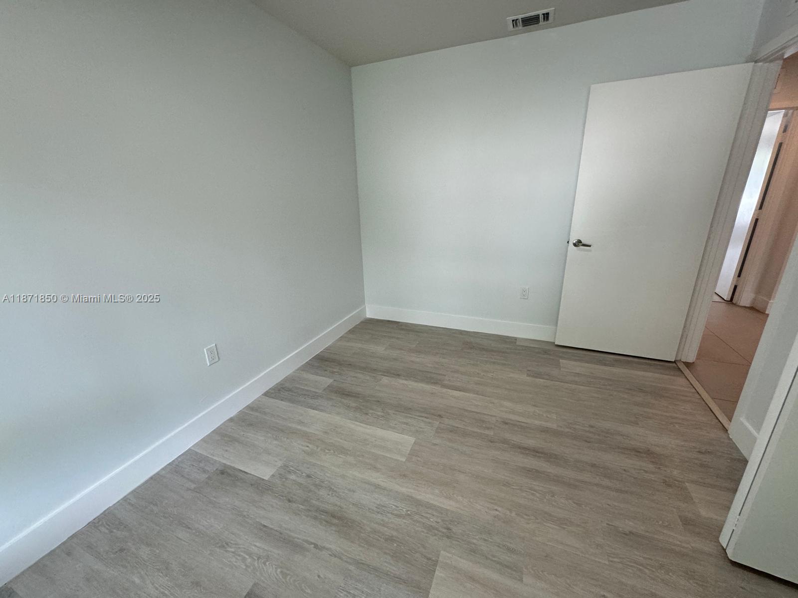 2555 Northeast 193rd Street, Unit 2106 Miami, FL 33180 - Photo 11 of 14 wooden floor in an empty room
