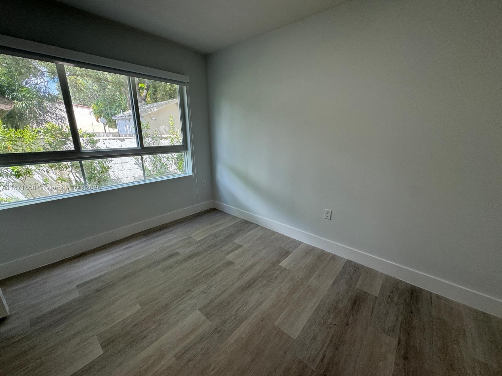 2555 Northeast 193rd Street, Unit 2106 Miami, FL 33180 - Photo 13 of 14 an empty room with wooden floor and windows