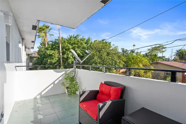 a view of a living room with furniture and a potted plant