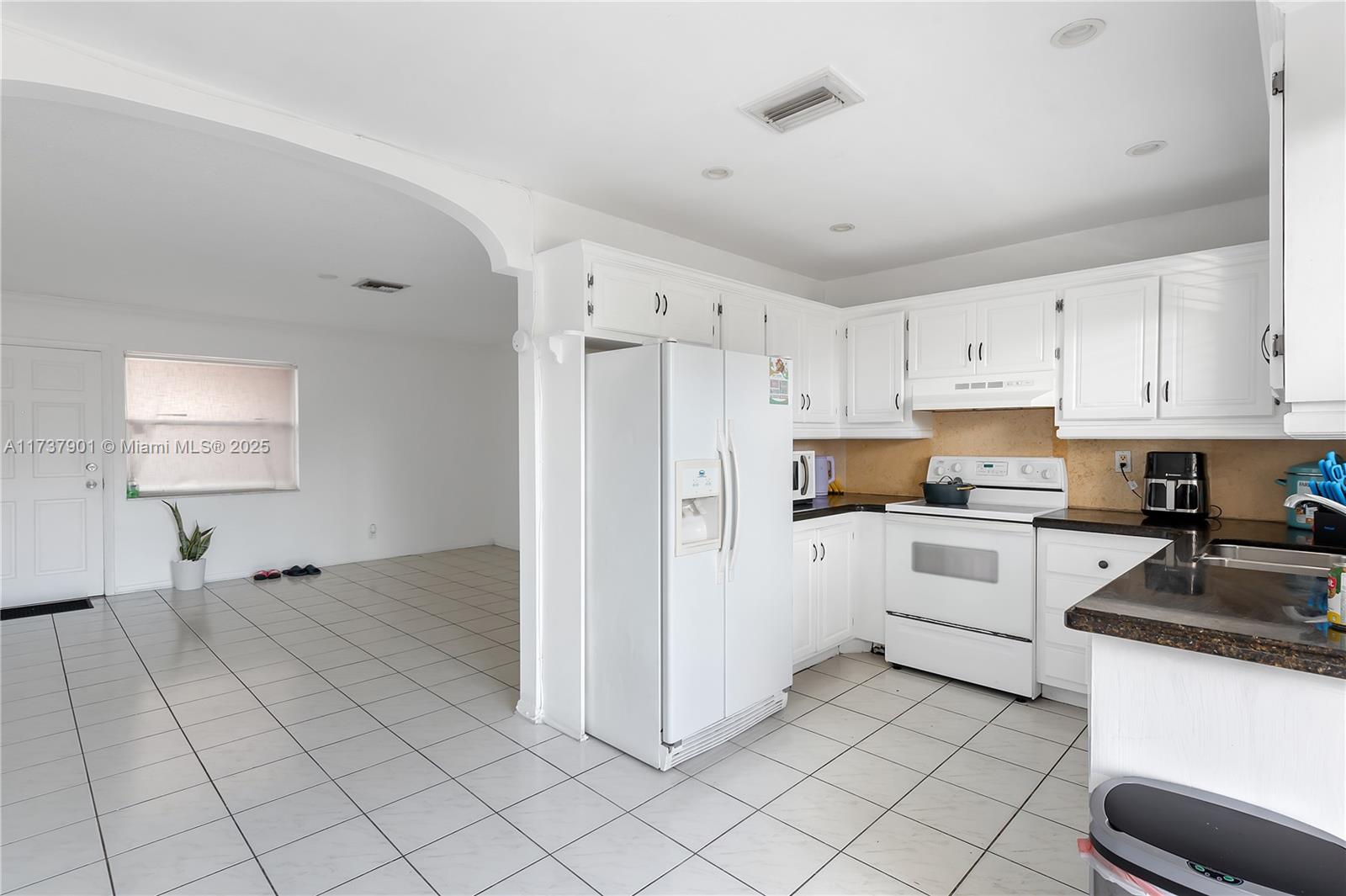 222 Southwest 1st Street, Unit H6 Pompano Beach, FL 33060 - Photo 6 of 15 a kitchen with white cabinets and white appliances