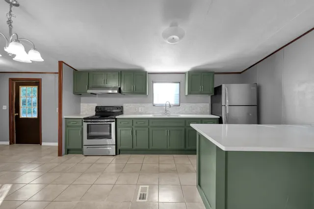 a kitchen with a sink and refrigerator
