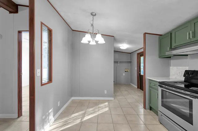 a view of a kitchen and a stove cabinet mirror