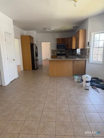 a kitchen with stainless steel appliances granite countertop a refrigerator and a stove top oven
