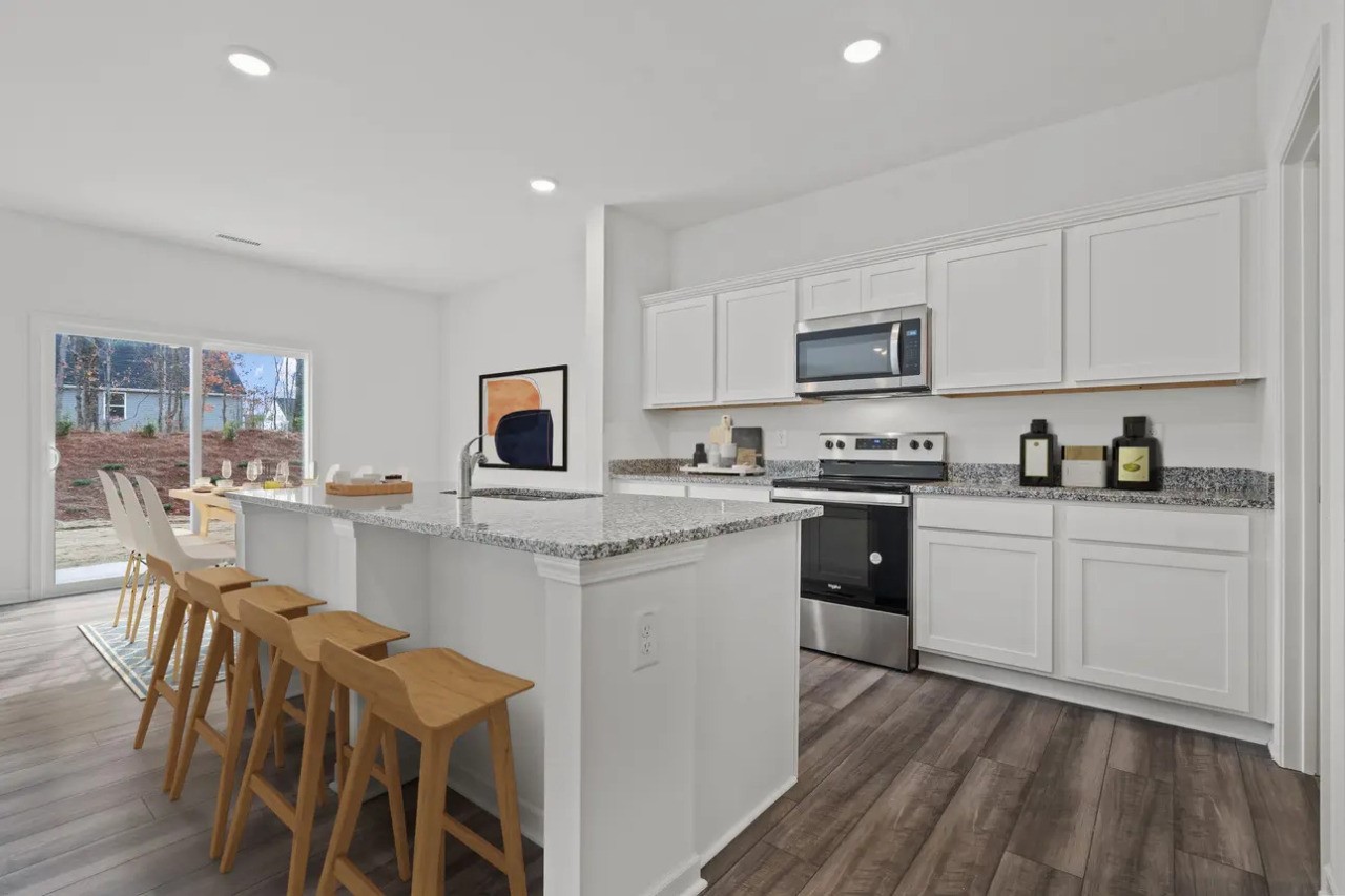 3103 Diamond Vw Lane Angleton, TX 77515 - Photo 2 of 17 a kitchen with stainless steel appliances granite countertop white cabinets a sink dishwasher a stove and a refrigerator with wooden floor