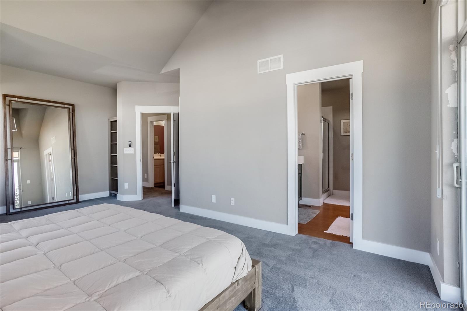 3219 Spruce Street Denver, CO 80238 - Photo 16 of 50 a bedroom with a bed and a mirror