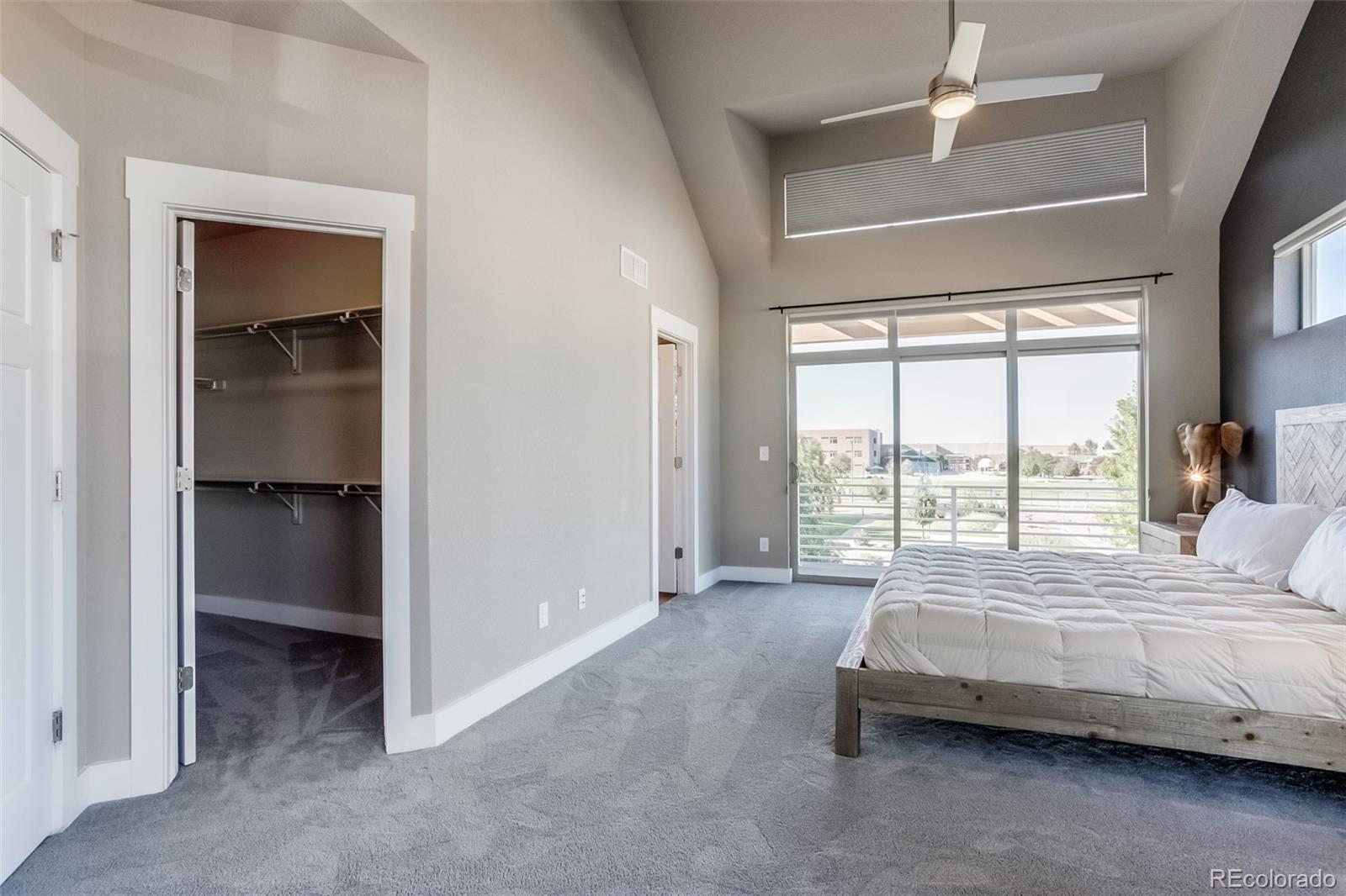 3219 Spruce Street Denver, CO 80238 - Photo 19 of 50 a bedroom with a bed and a large window with balcony view