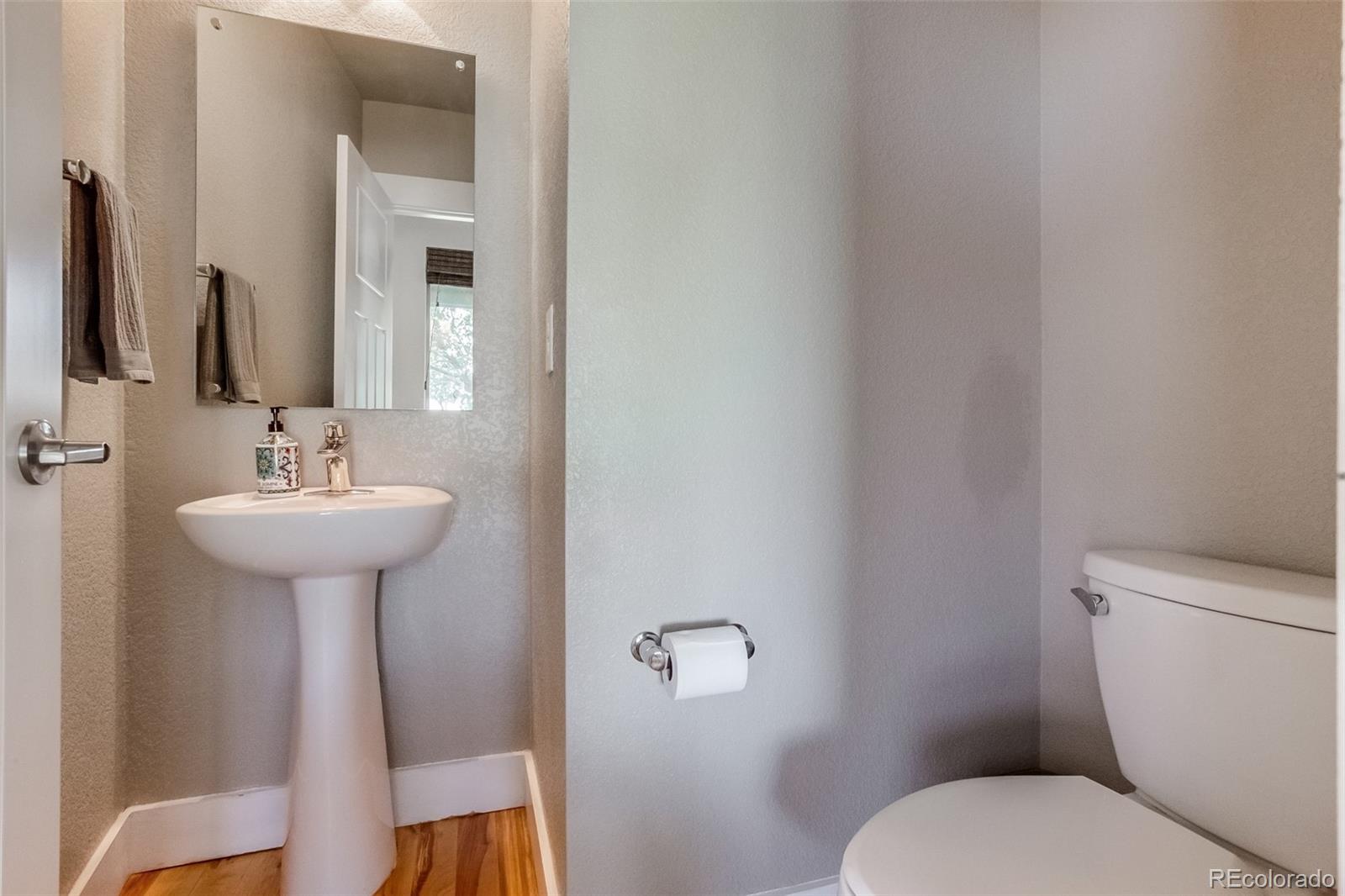 3219 Spruce Street Denver, CO 80238 - Photo 37 of 50 a bathroom with a sink a mirror and a toilet