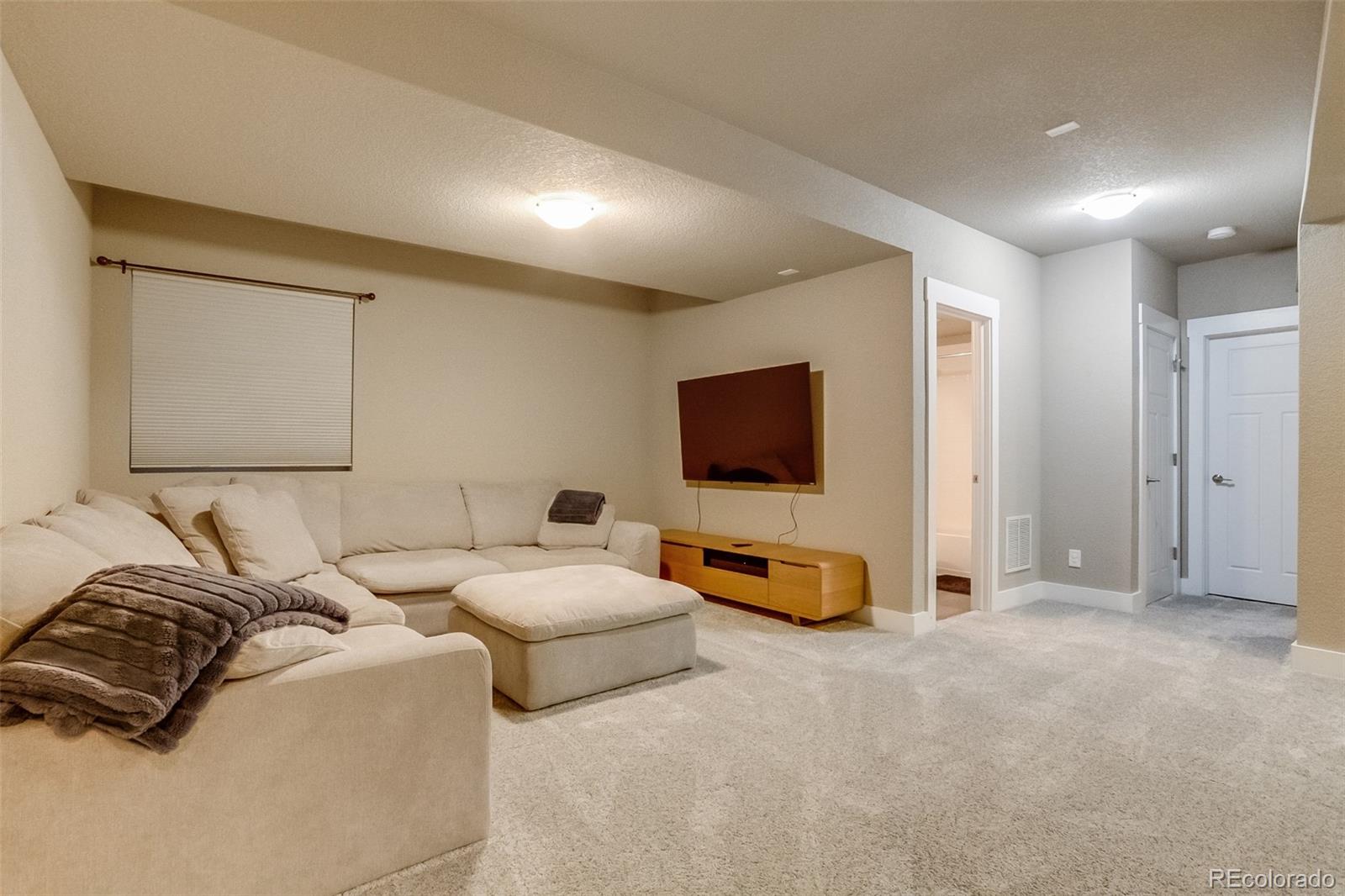 3219 Spruce Street Denver, CO 80238 - Photo 39 of 50 a bedroom with furniture and a flat screen tv