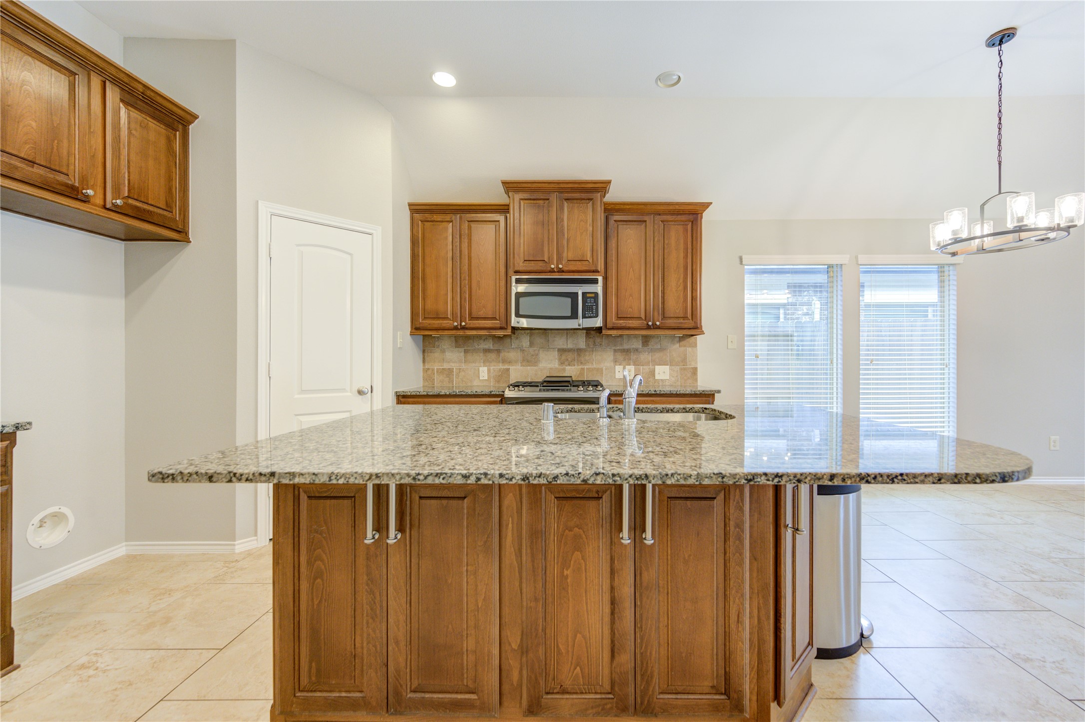 27407 Gatlin Lane Spring, TX 77386 - Photo 14 of 35 Anchored by a generous granite island, this kitchen offers abundant workspace, seating, and storage for everyday living. Custom cabinetry, stainless steel appliances, and timeless finishes combine to create a space that is as practical as it is inviting.