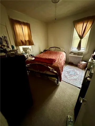 a bedroom with a bed and window