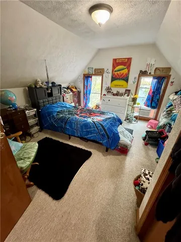 a bedroom with bed and furniture