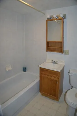 a bathroom with a sink a toilet and bathtub