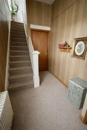 a view of entryway with stairs and wooden floor