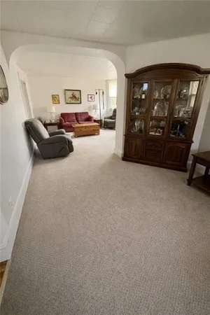 a living room with furniture a large window and a flat screen tv