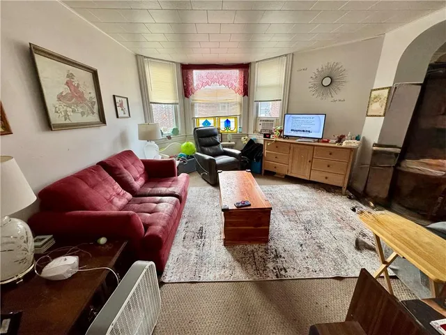 a living room with furniture fireplace and a flat screen tv