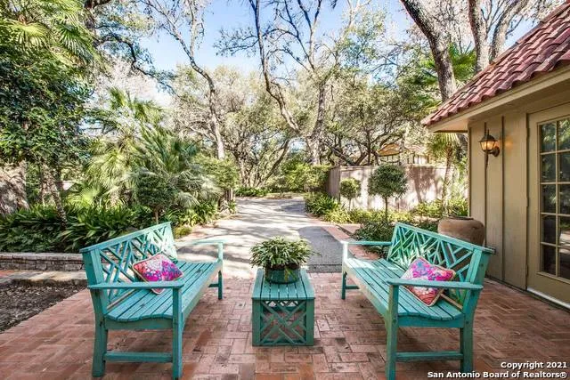 a backyard of a house with barbeque oven table and chairs