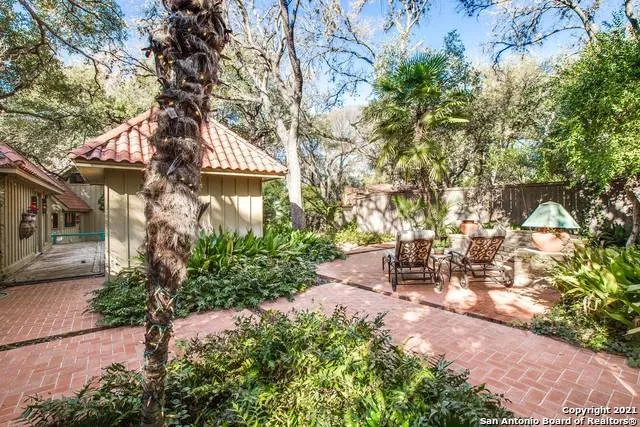 a view of a patio with table and chairs and potted plants