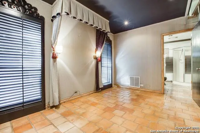 a view of a porch with a wooden floor and next to a window