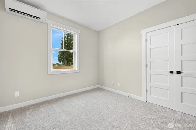 an empty room with windows and closet