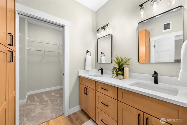 a bathroom with a double vanity sink mirror and