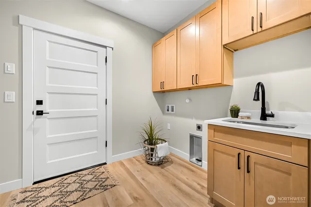a kitchen with a window a sink and cabinets
