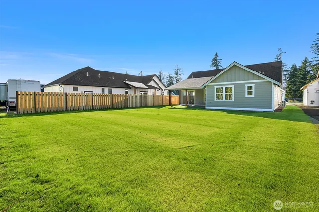 a front view of a house with yard and green space
