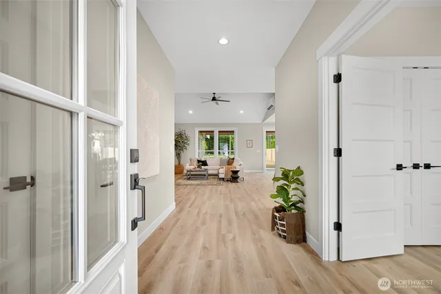 a view of a hallway view with wooden floor and furniture