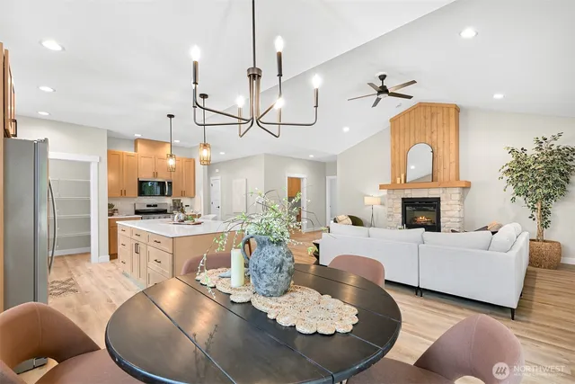 a living room with furniture a fireplace and a chandelier