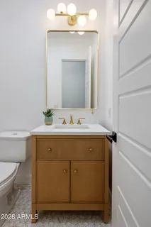 a bathroom with a granite countertop sink a mirror and shower