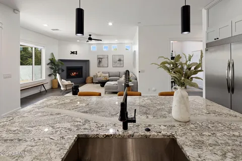 a kitchen with stainless steel appliances granite countertop a stove a sink and a refrigerator