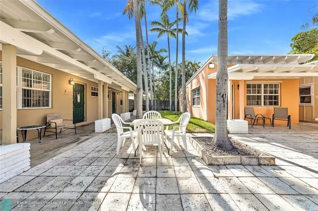 a view of a patio with table and chairs and potted plants
