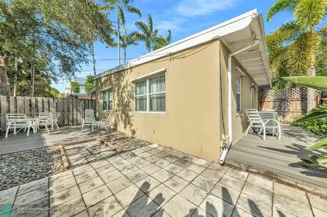 a view of a backyard with sitting area