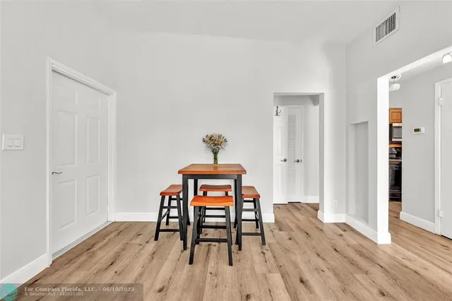 a dining room with furniture and wooden floor