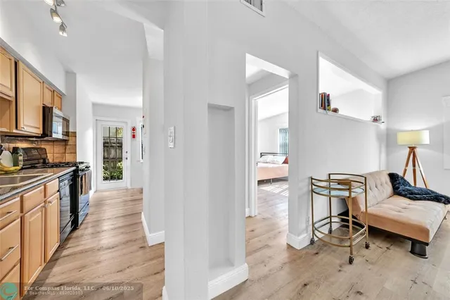 a kitchen with a refrigerator and a stove