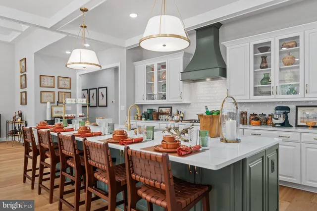 a kitchen with stainless steel appliances a table chairs and chandelier