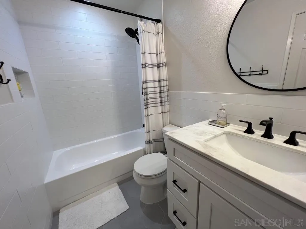 6805 Maple Leaf Drive Carlsbad, CA 92011 - Photo 14 of 22 a bathroom with a sink a toilet and shower