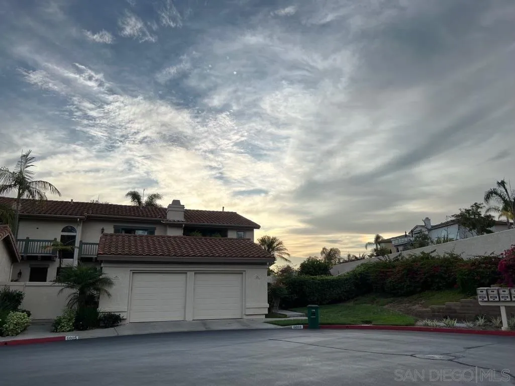6805 Maple Leaf Drive Carlsbad, CA 92011 - Photo 2 of 22 a tall building in the middle of a yard