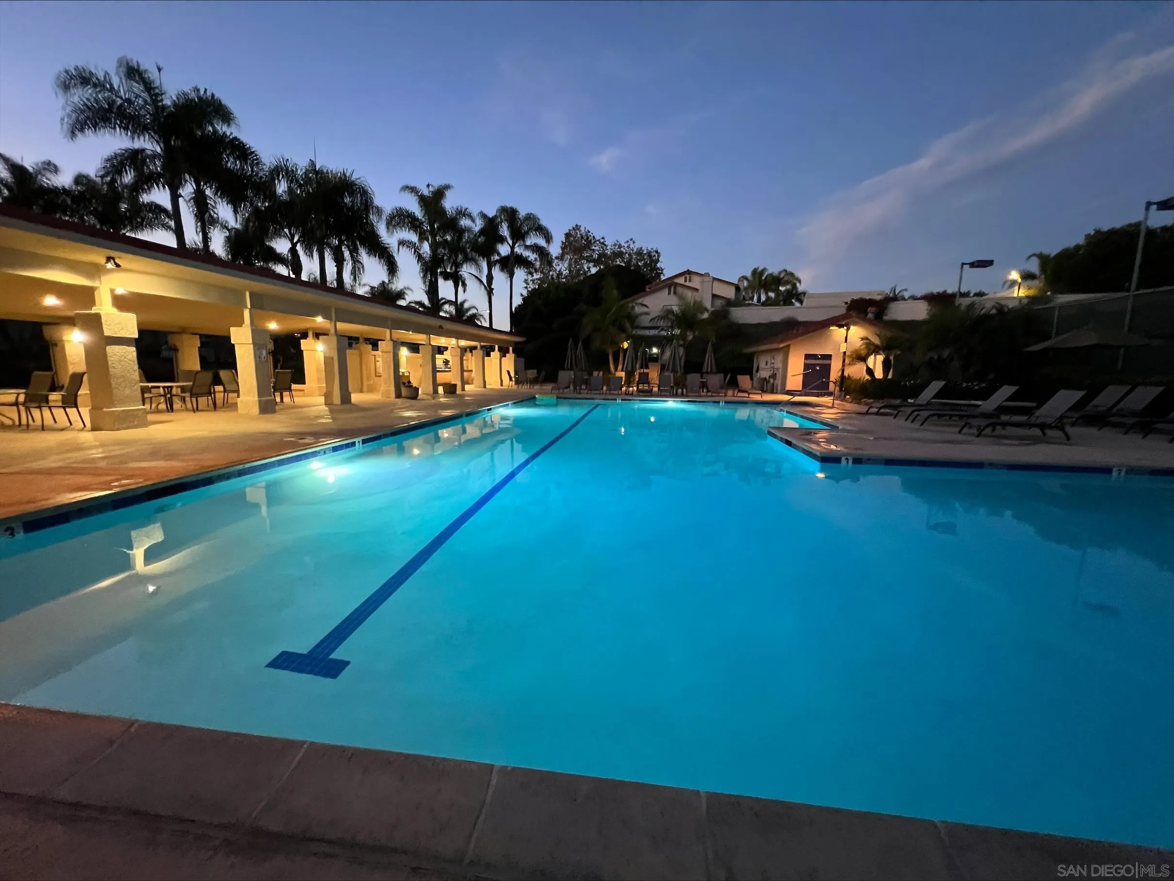 6805 Maple Leaf Drive Carlsbad, CA 92011 - Photo 22 of 22 a view of a yard with table and chairs potted plants and wooden floor