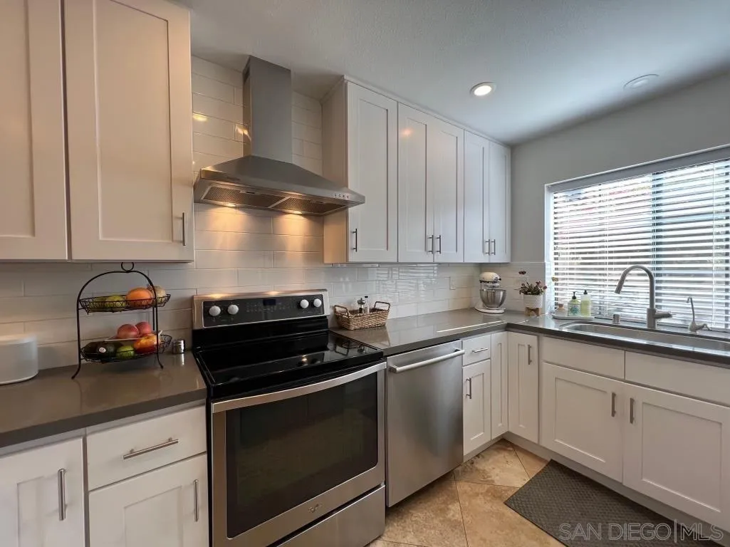 6805 Maple Leaf Drive Carlsbad, CA 92011 - Photo 5 of 22 a kitchen with a sink and cabinets