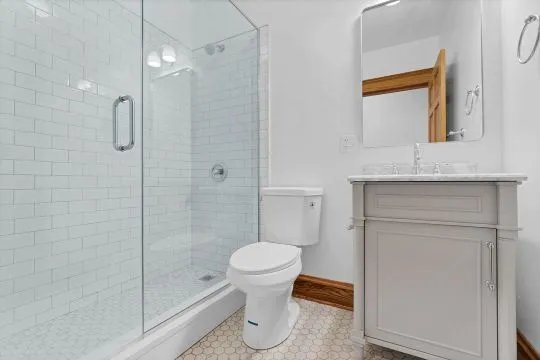 a bathroom with a toilet sink and shower