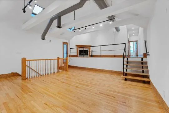 a view of entryway with stairs and wooden floor