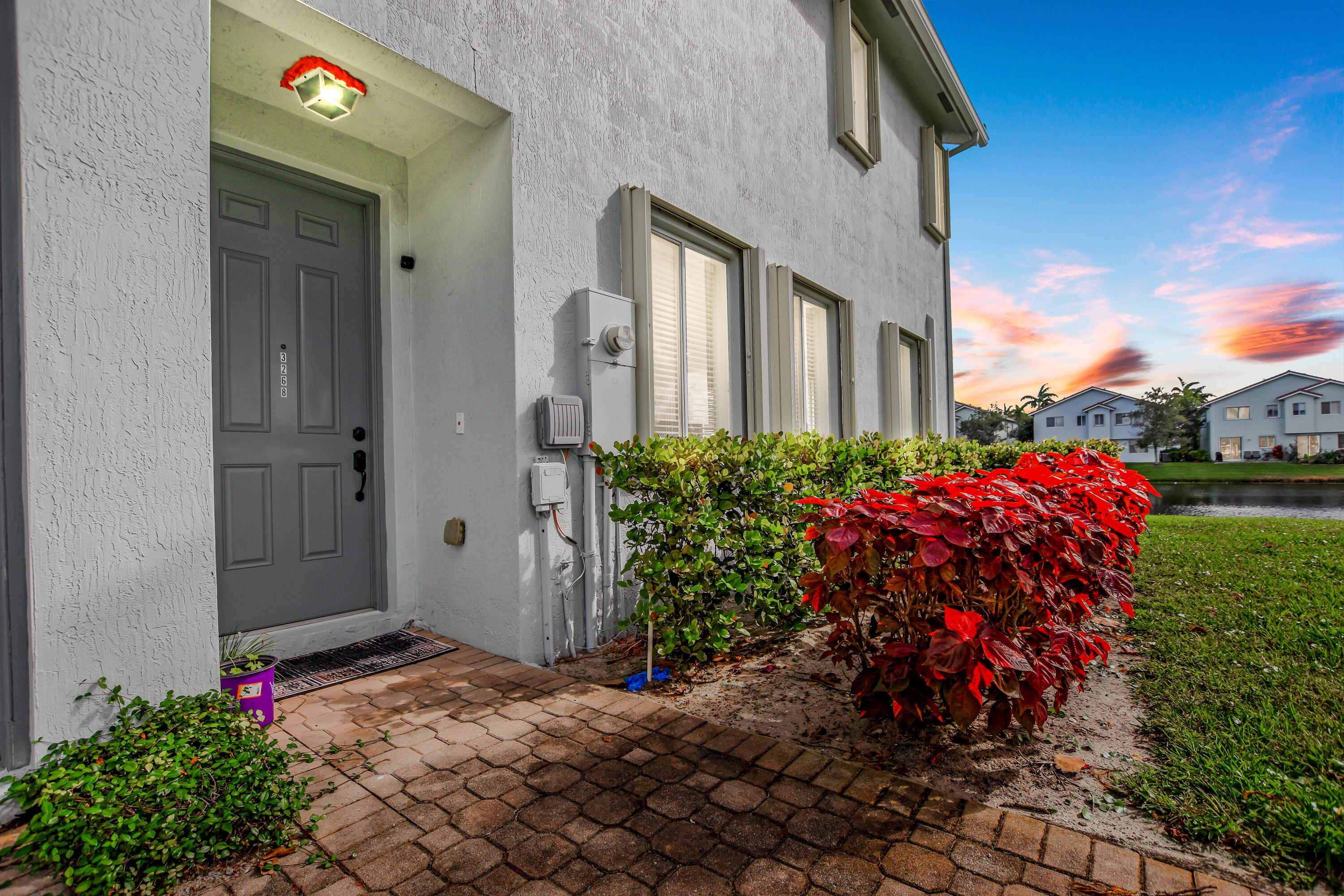 3268 Laurel Ridge Circle Riviera Beach, FL 33404 - Photo 22 of 33 Front Door Twilight