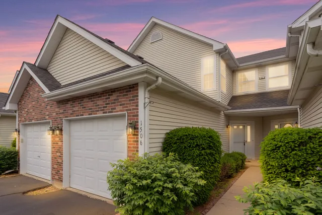 a front view of a house with plants