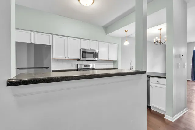 a kitchen with a sink stove and white cabinets
