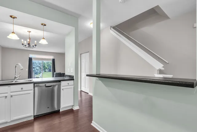 a view of a kitchen with stainless steel appliances a refrigerator and a stove top oven