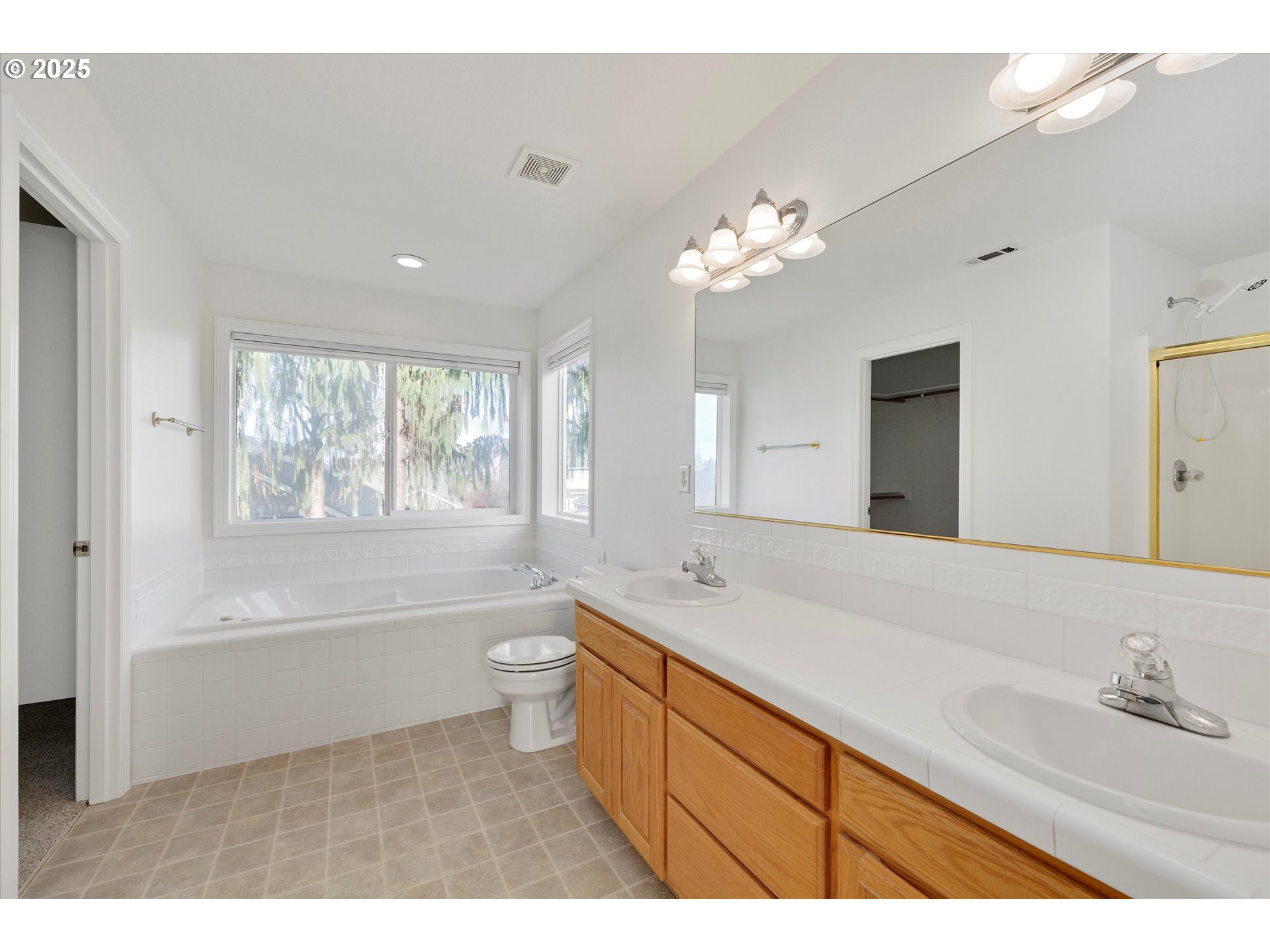 1380 Southeast 9th Avenue Canby, OR 97013 - Photo 12 of 21 a bathroom with a bathtub a sink and a large mirror